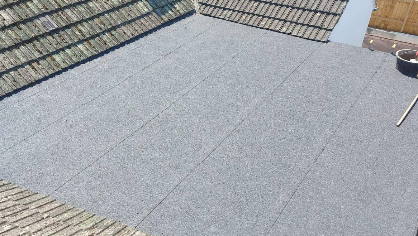Completed single-ply flat roof with neatly welded upstands and trims
