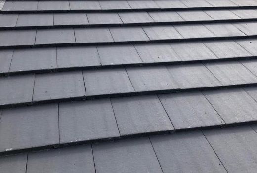 Newly laid grey concrete roof tiles across a clean, finished roof slope