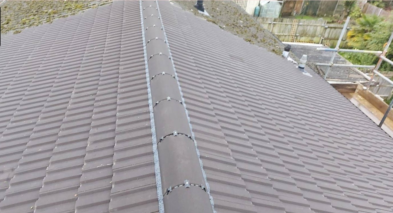 Grey tiled roof ridge finished with a dry fix ridge system