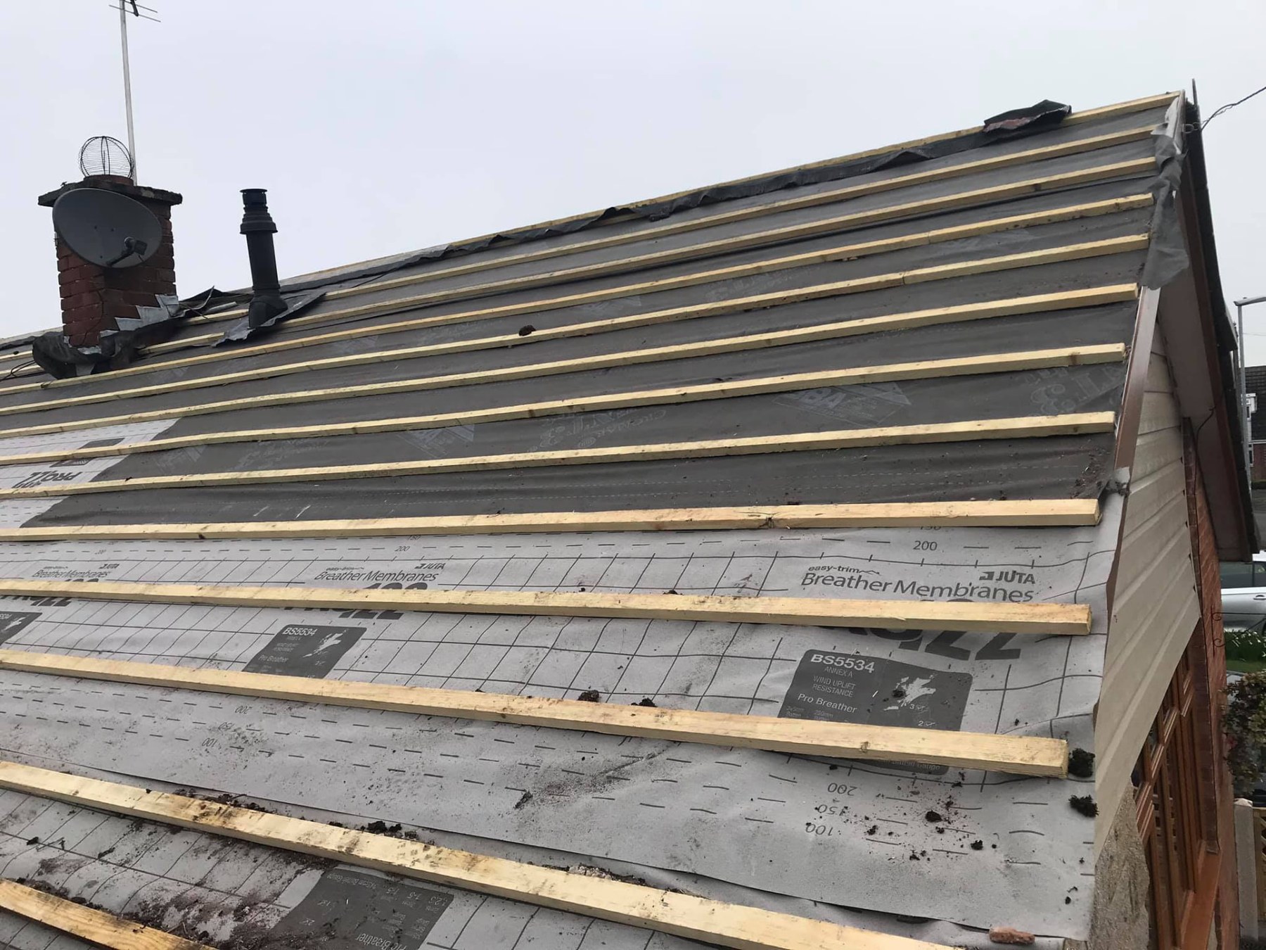 Roof stripped back to felt and battens, the stage at which loft insulation is upgraded